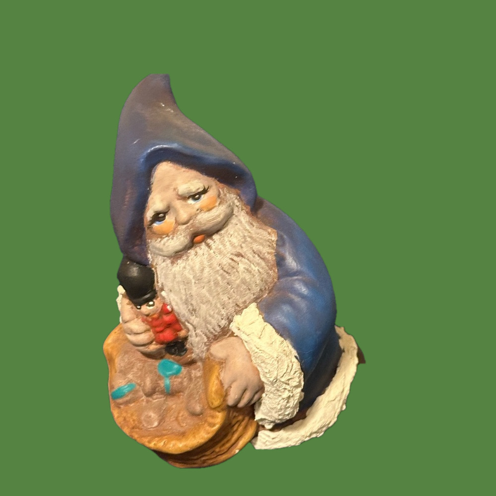 Cute blue robed kneeling Santa. He carries a basket of gifts.